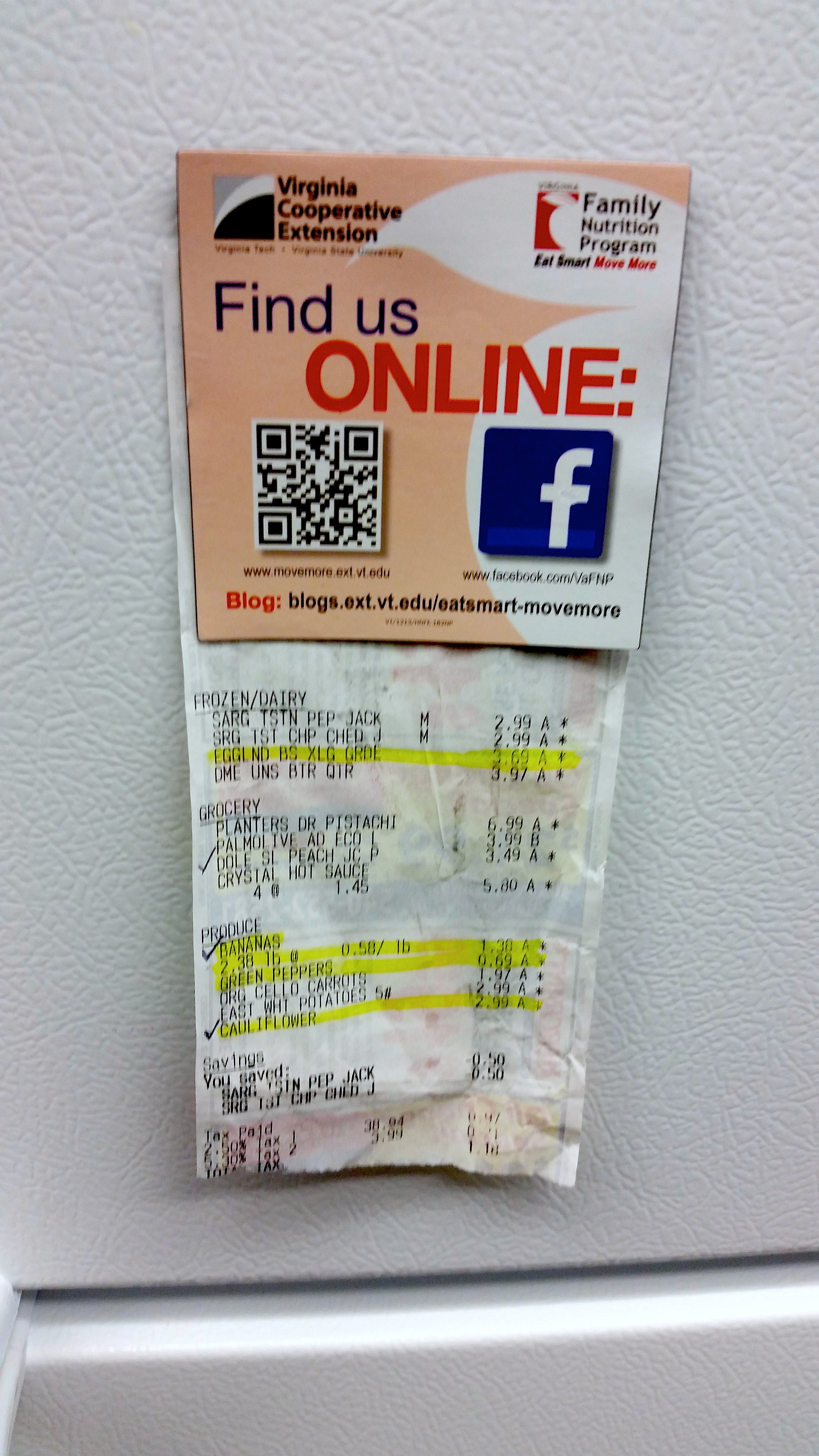 grocery receipt hung on refrigerator door using magnet