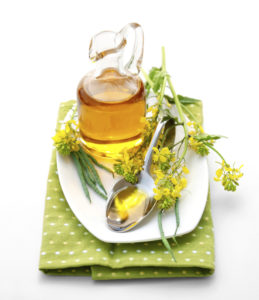 canola oil in a bottle with canola flowers