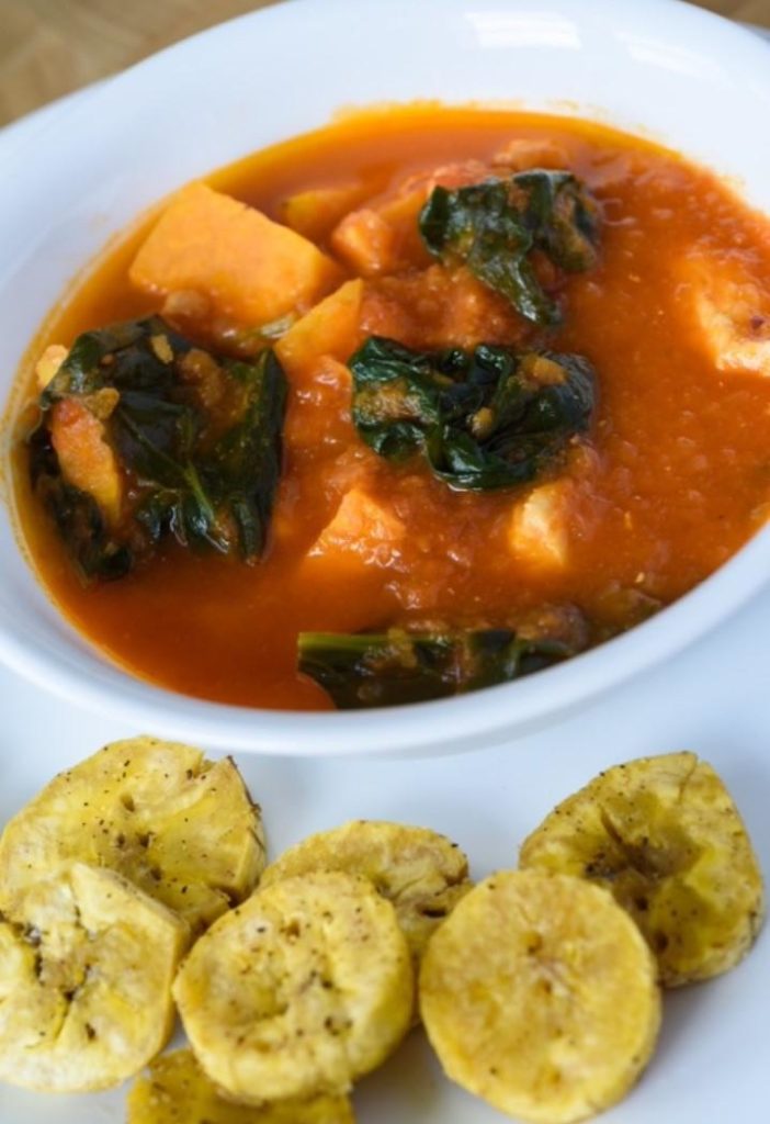 Nigerian meal of chicken stew with fried plantains