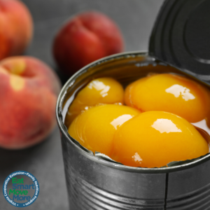 An open can of yellow peaches. 