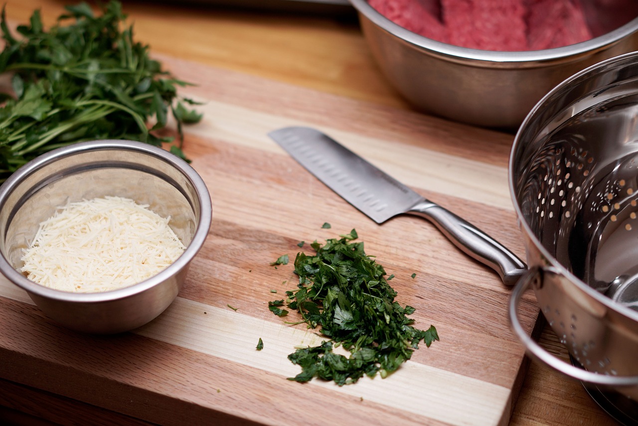 kitchen counter with cutting board, knife, and ingredients