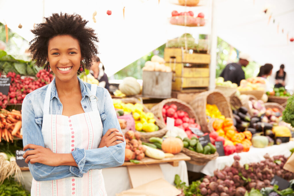 Woman standing at a farmer's market stand